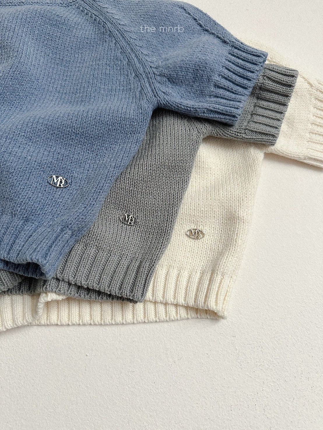 28.Emblem 3/4 Sleeve Knit Top