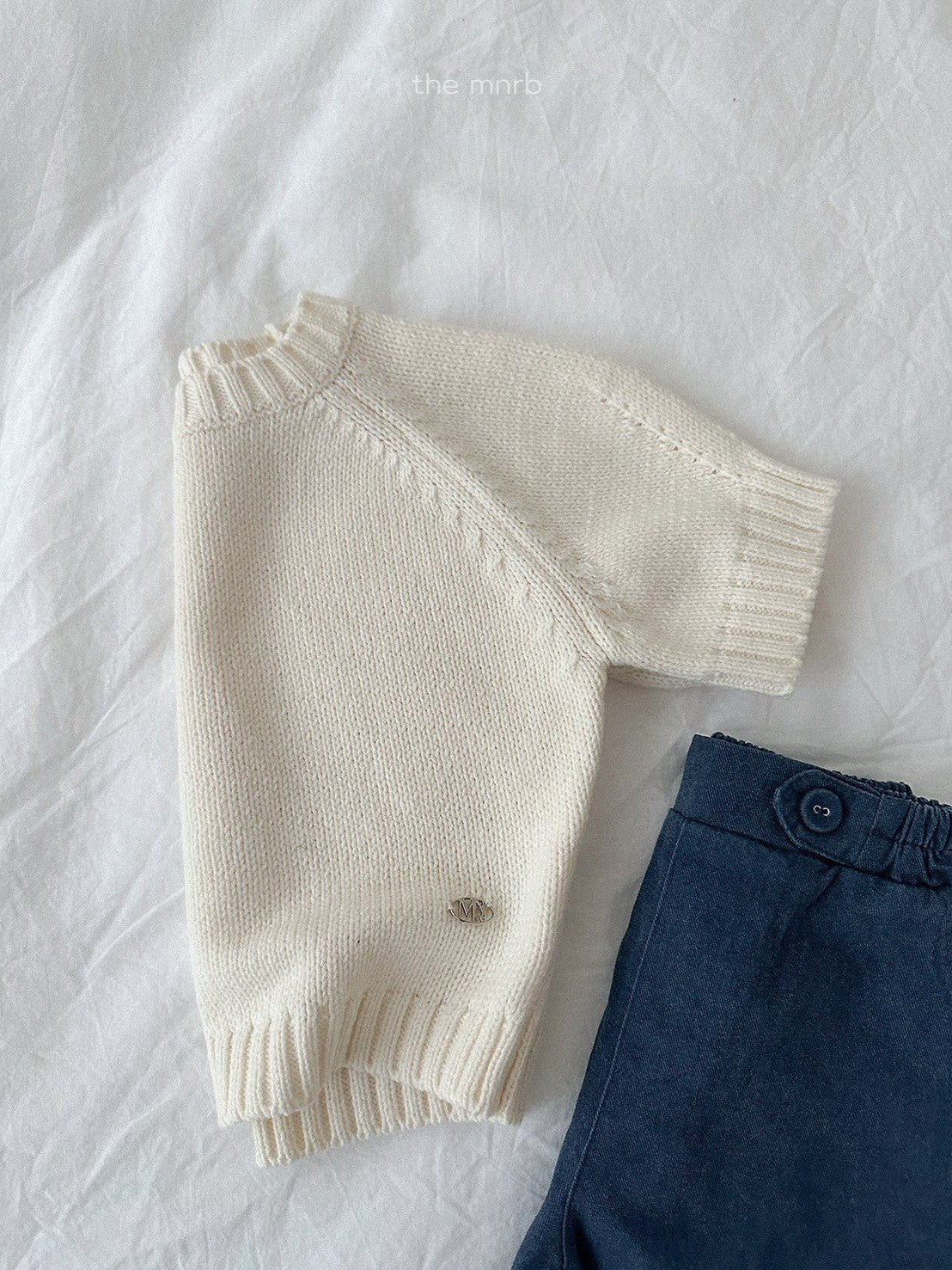 28.Emblem 3/4 Sleeve Knit Top